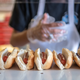 a line of hot dogs being prepared